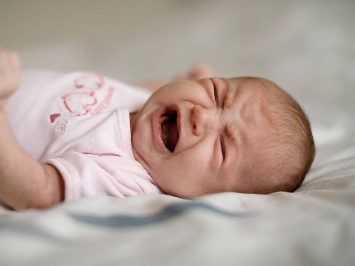 crying baby in pink outfit