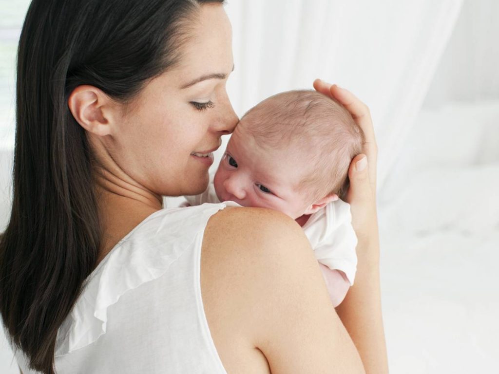 Smiling mother holding baby