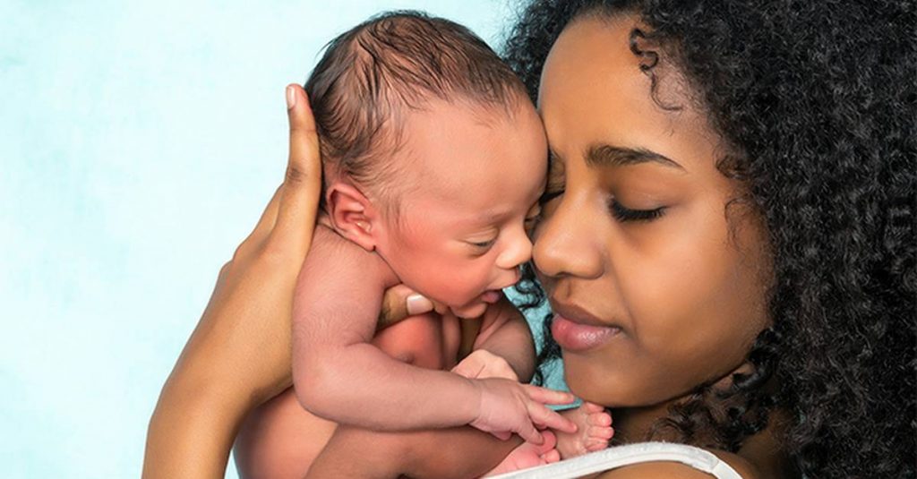 mother holding her baby close