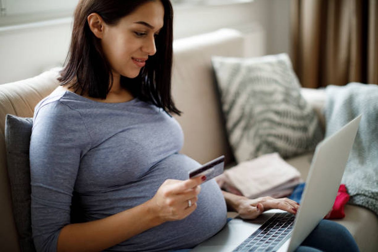 pregnant woman shopping online with credit card