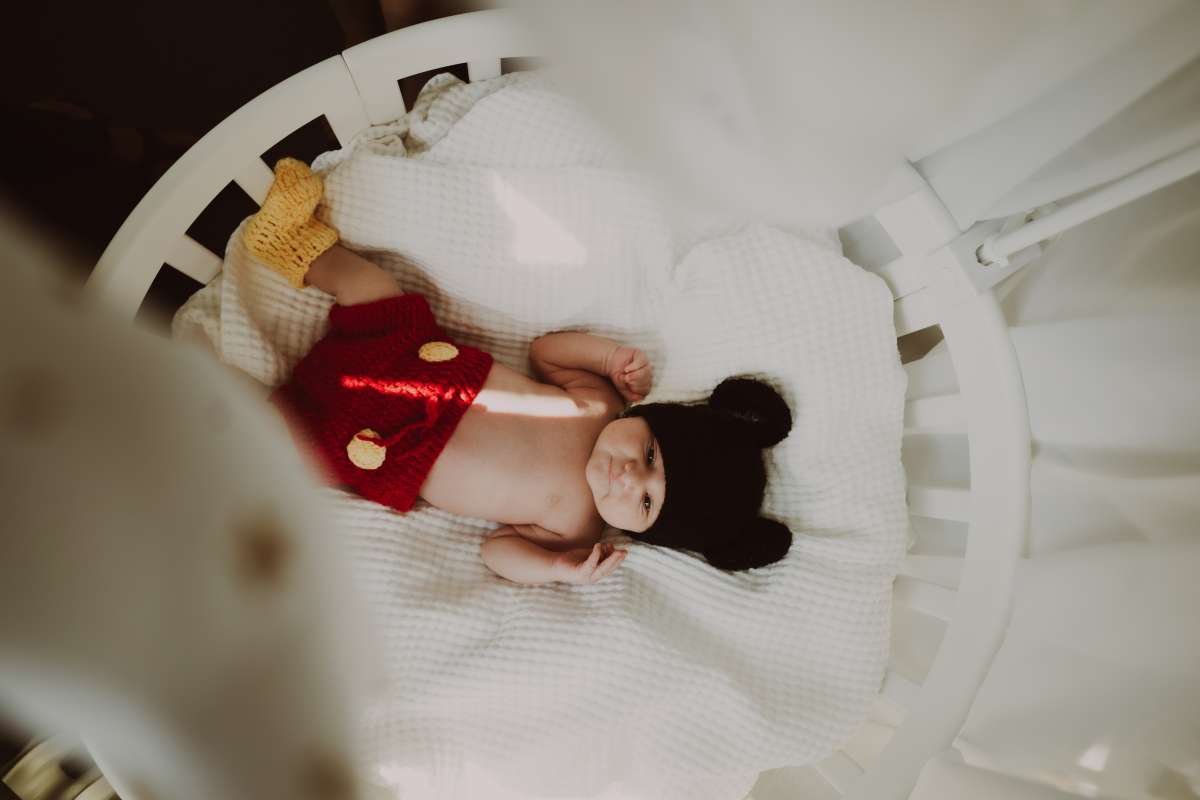 Baby keeps hitting head clearance on crib